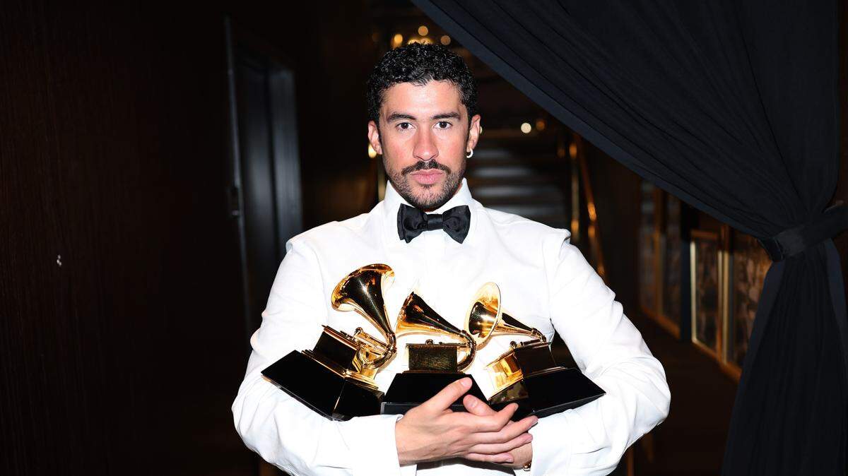 Bad Bunny poses with his Album of the Year, Best Musica Urbana Album and Best Global Music Performance awards during the Grammys on Sunday.