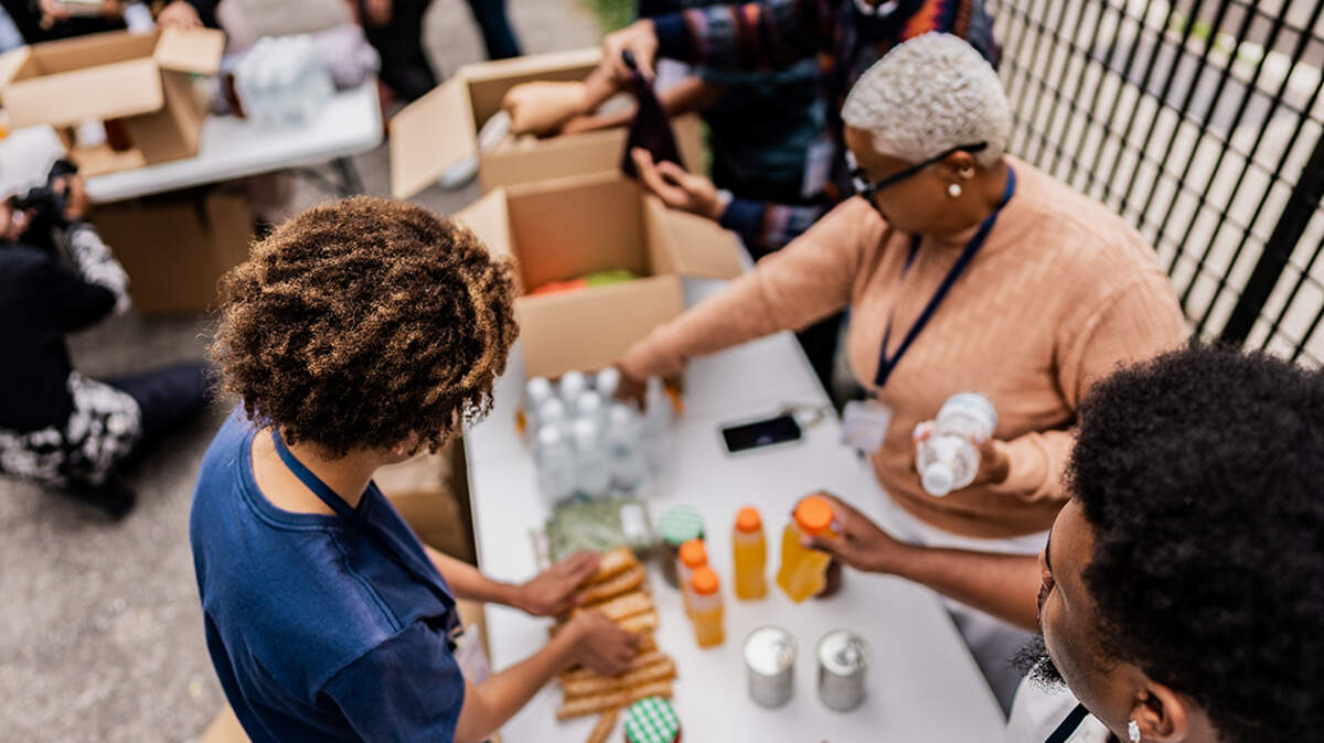 Teenage volunteer sorting donations during community service food bank nutrition assistance