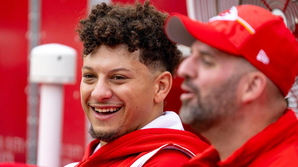 Kansas City Chiefs quarterback Patrick Mahomes (15) laughs while sitting on the bench before an NFL preseason football game against the Cleveland Browns on Saturday, Aug. 26, 2023, in Kansas City.