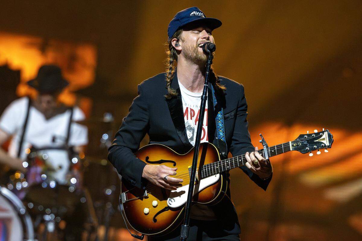 Wesley Schultz of The Lumineers sings and plays guitar while performing “Angela” on Saturday. The band combined some of its greatest hits with newer music.