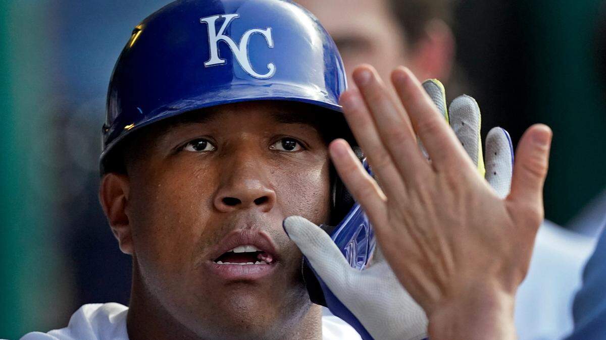 Kansas City Royals’ Salvador Perez celebrates in the dugout after hitting a two-run home run during the third inning of a baseball game against the Chicago White Sox Saturday, Sept. 4, 2021, in Kansas City, Mo. (AP Photo/Charlie Riedel)