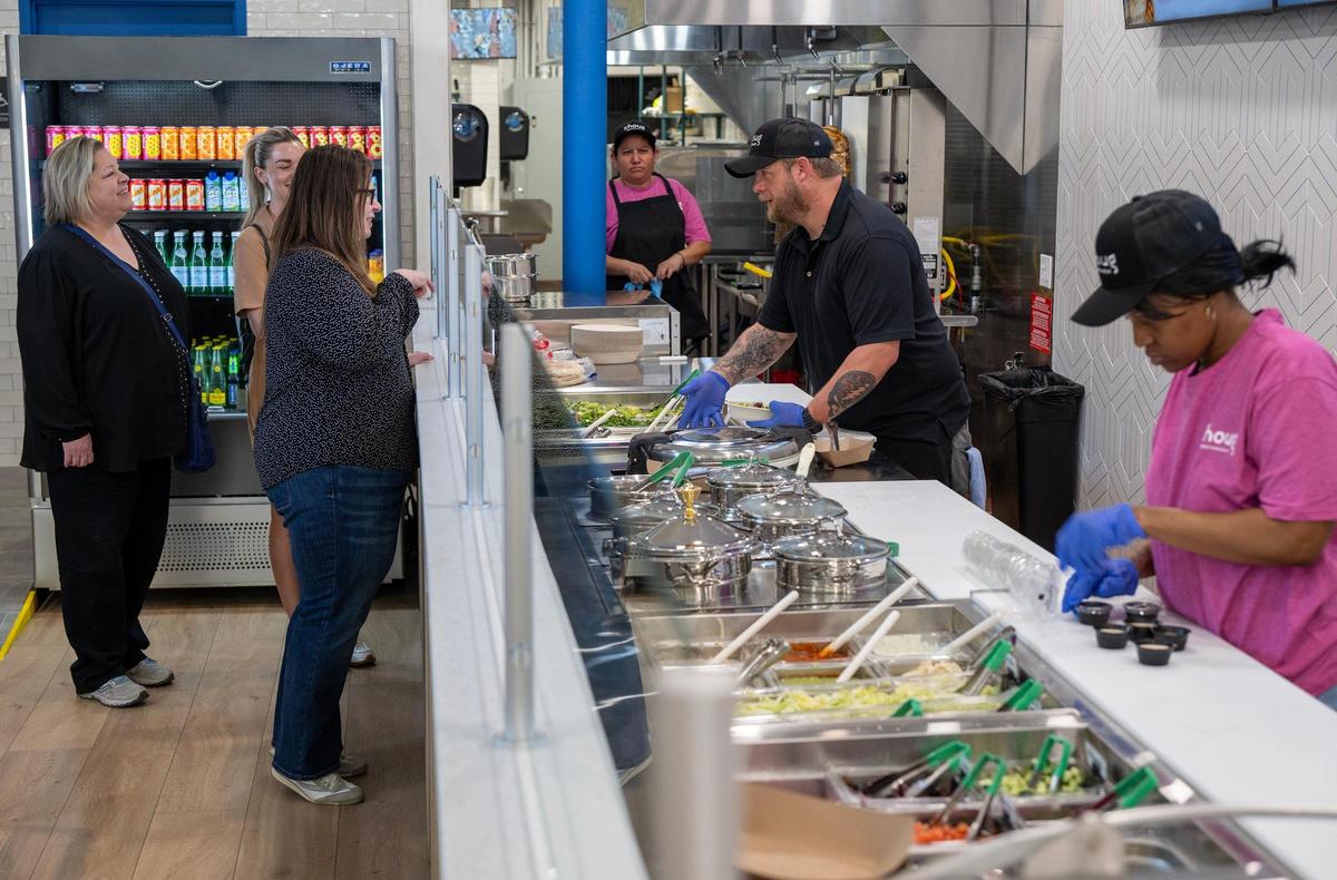 Customers waited to place orders with Ryan Moody during a soft opening at Zhoug Mediterranean on May 14 in Kansas City.