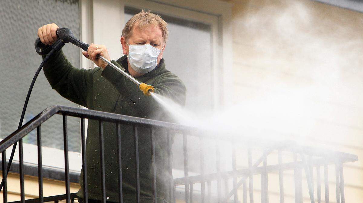 Man using a power wash.