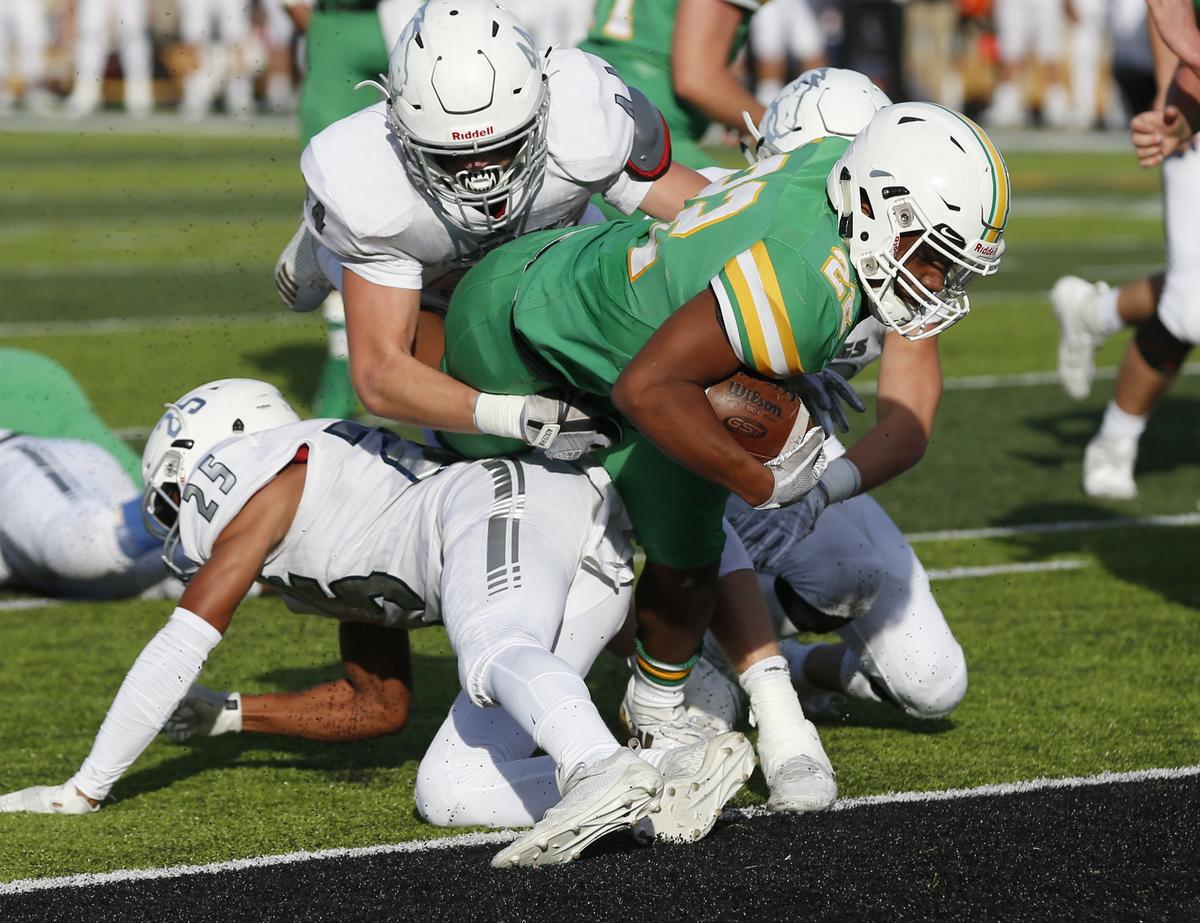 Derby running back Tre Washington dives over the goal line for a touchdown Saturday. Washington had three TD’s on the day with the longest at 69 yards as Derby beat Blue Valley North 24-16.