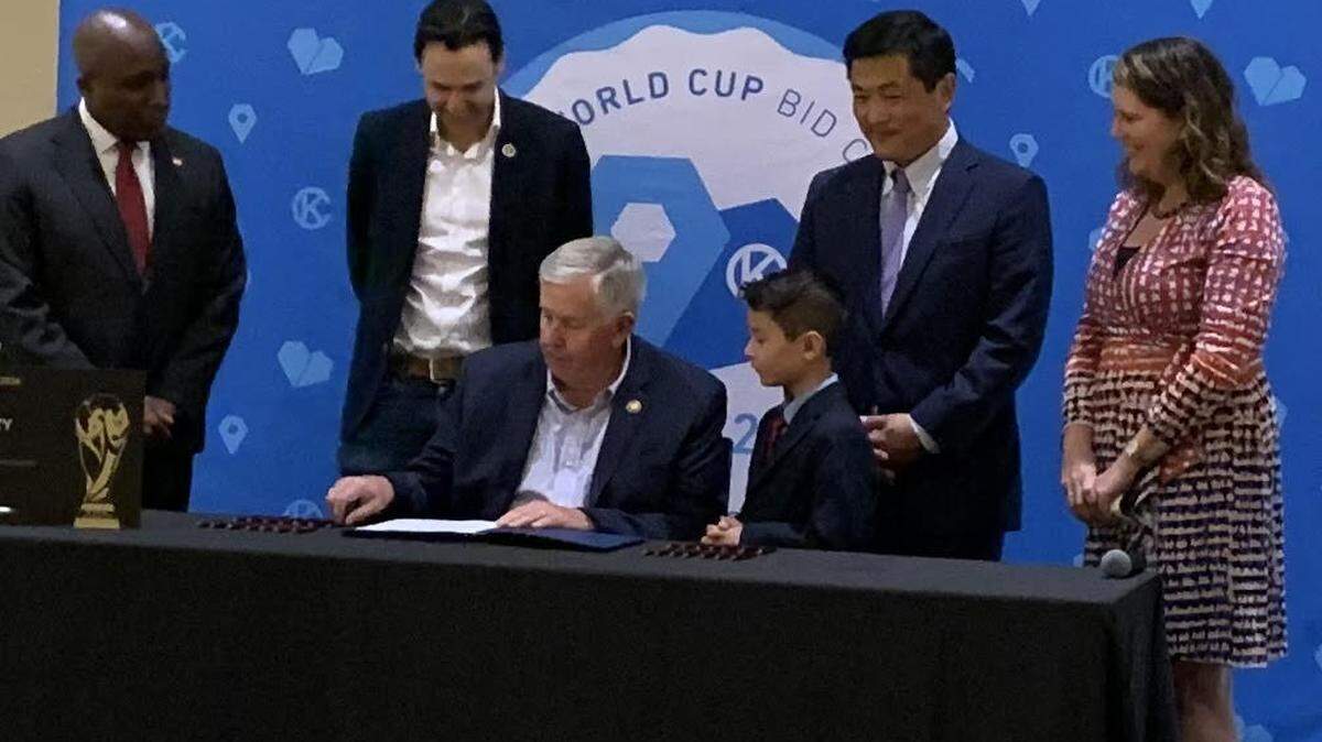 Missouri Gov. Mike Parson signs a bill Thursday at Arrowhead Stadium exempting World Cup tickets from sales tax.