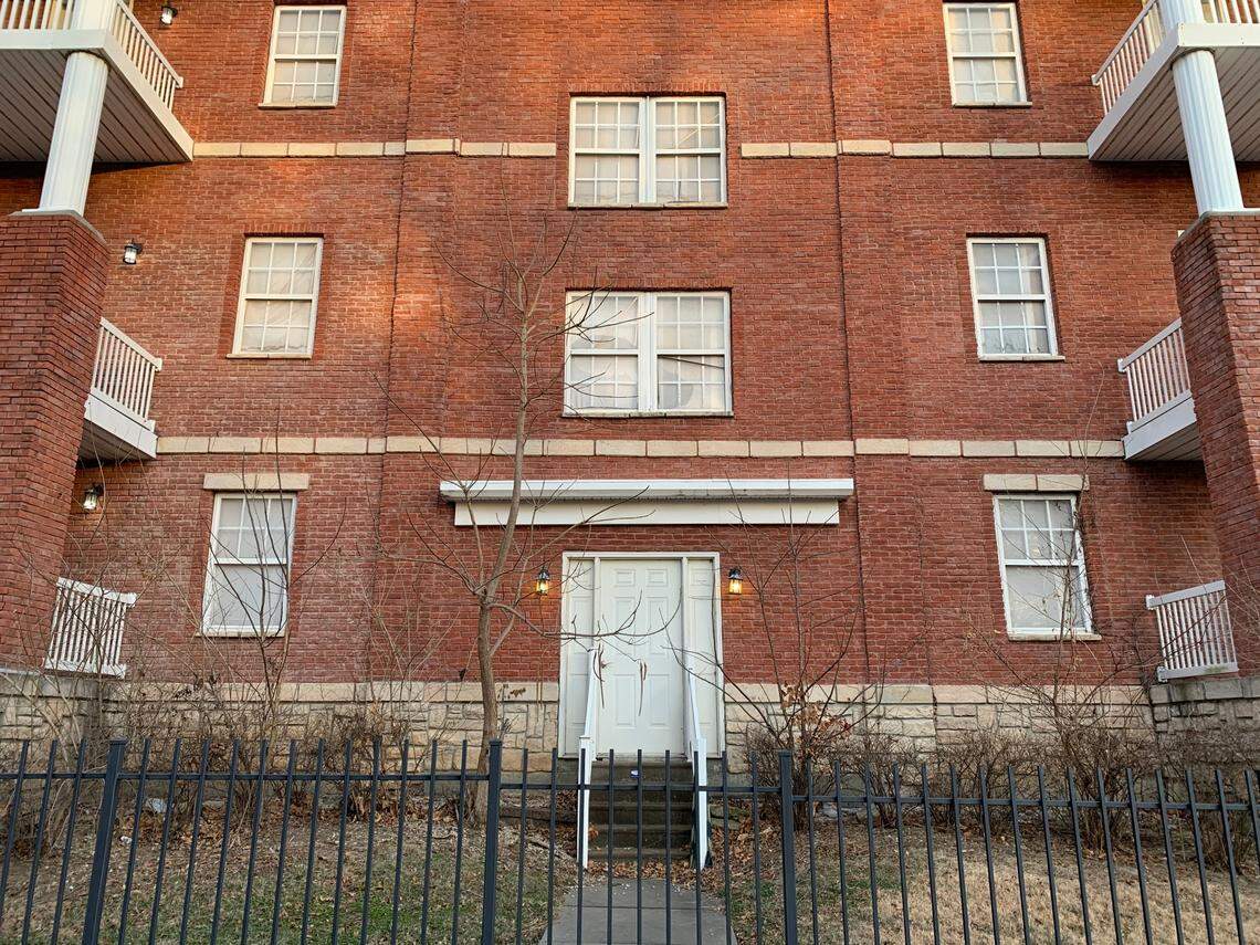 The doors and windows are boarded up at the facade apartments on Baltimore Avenue.