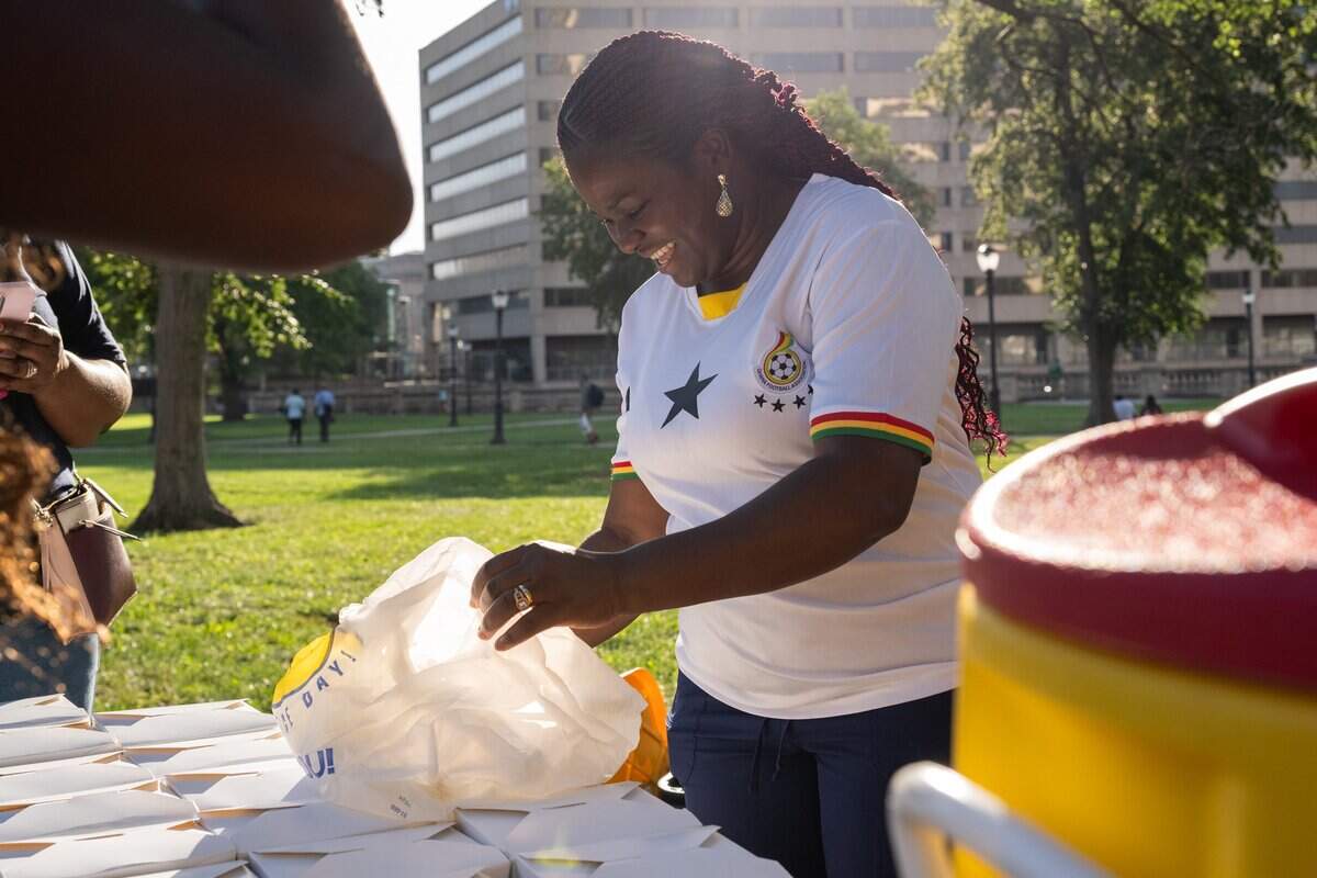 Mercy Kwenortey bags food at a ‘jama,’ Ghanian for cheer or rally, on Thursday, July 2, 2026, the day before the Ghana soccer team faces Colombia in a Round of 32 match in Kansas City.