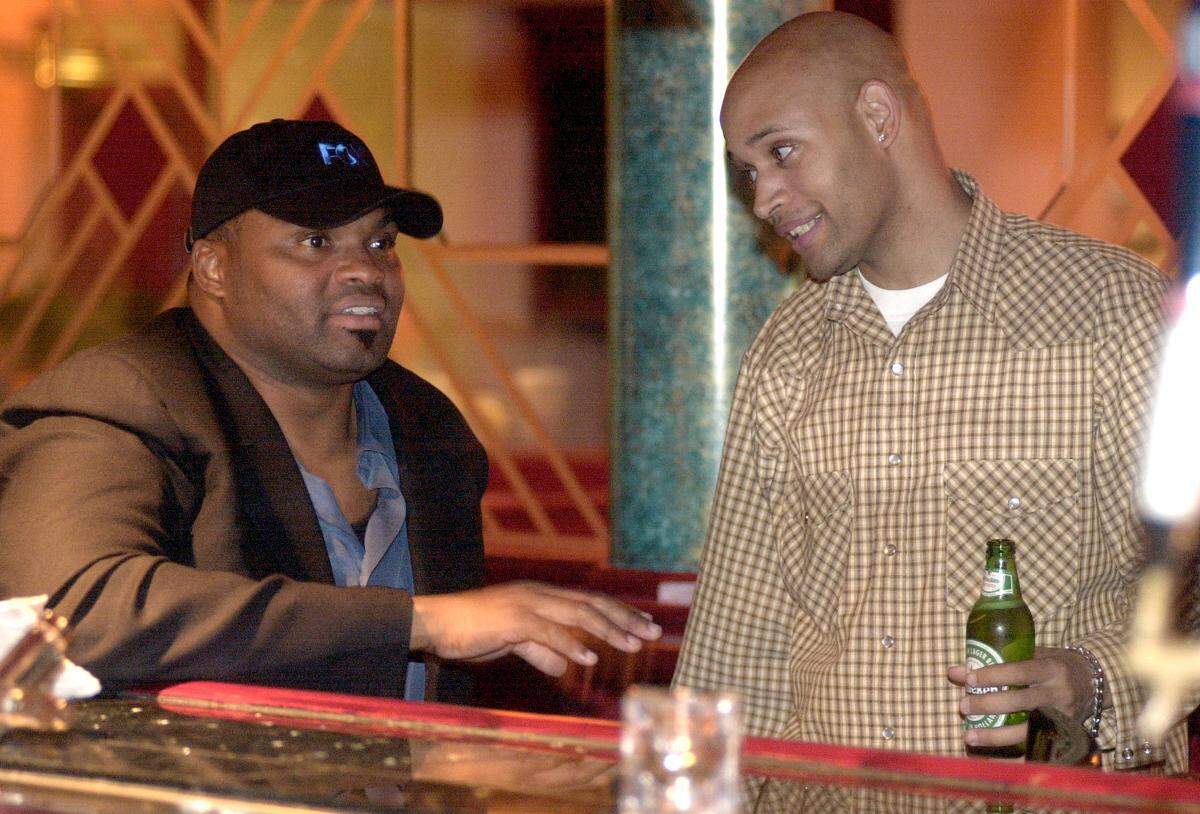 Former Kansas City Chiefs player Neil Smith talks with Damion Henderson of Kansas City at Copeland's, 11920 Metcalf Ave. during a Chiefs afterparty in 2004. Every Sunday after a home game, the establishment offered a postgame celebration point popular with Chiefs players.