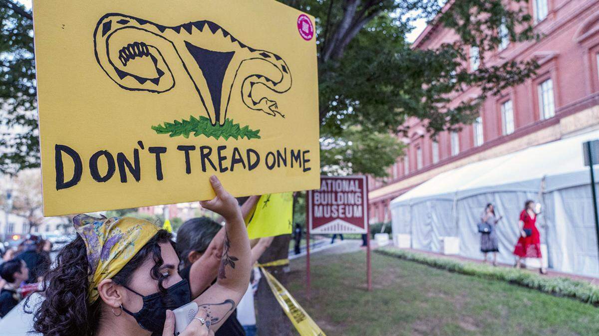 Abortion rights protesters display placards as people arrive to attend an event sponsored by Susan B. Anthony Pro Life America at the National Building Museum, Tuesday, Sept. 13, 2022, in Washington. (AP Photo/Gemunu Amarasinghe)