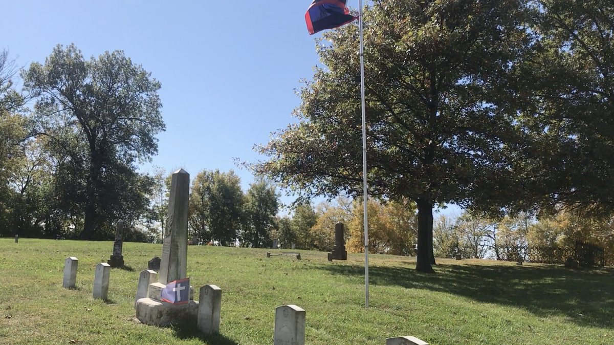 In Platte County, the white cross of the Confederate Missouri Battle Flag flutters at a monument that marks the graves of six Confederate soldiers who died at a battle in 1864 in nearby Camden Point.