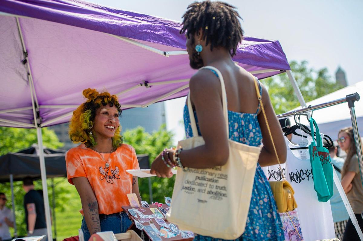 Erika Sakata helps a customer at her booth during the AAPIconic on Saturday, May 20, 2023, in Kansas City.
