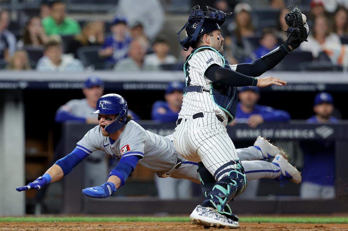 Kansas City Royals shortstop Bobby Witt Jr. (7) scores a run against New York Yankees catcher Austin Wells (28) on a single by Royals catcher Salvador Perez during the fifth inning at Yankee Stadium on Sept. 9.