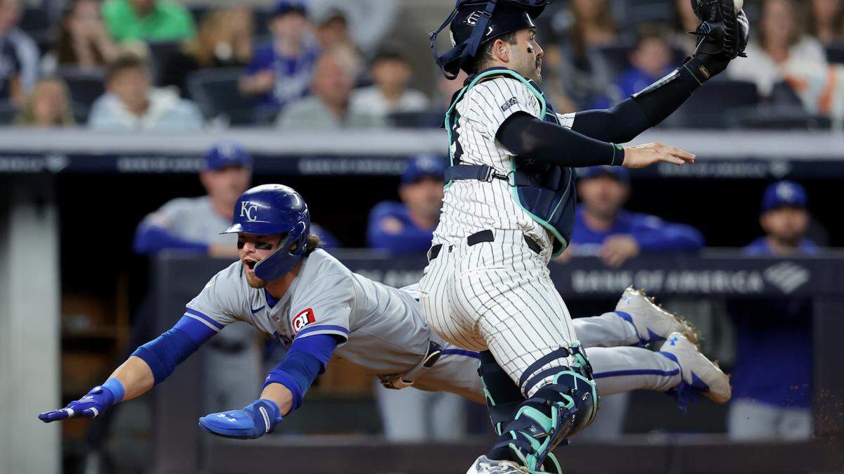 Kansas City Royals shortstop Bobby Witt Jr. (7) scores a run against New York Yankees catcher Austin Wells (28) on a single by Royals catcher Salvador Perez (not pictured) during the fifth inning at Yankee Stadium on Sept. 9.