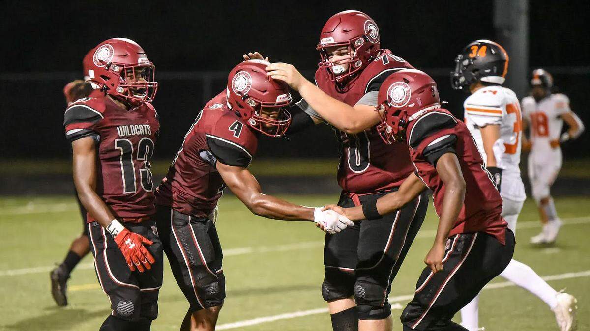 Washington High’s Antione Williams, Xavyer Powell, Jackson Billings and Ja’Quarey Williams celebrate during a 37-28 win over Bonner Springs.