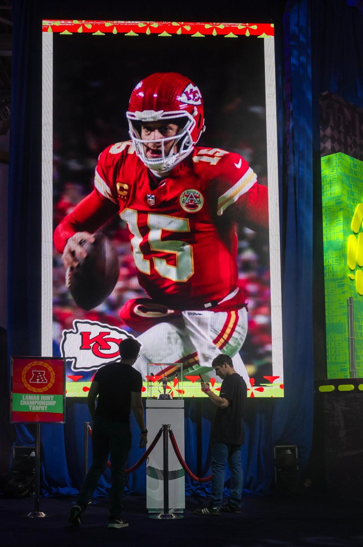 As a video of the Kansas City Chiefs played, visitors to the Super Bowl Experience stopped at the AFC Championship display to view the Lamar Hunt Trophy at the Ernest N. Morial Convention Center on Thursday, Feb. 6, 2025, in New Orleans.