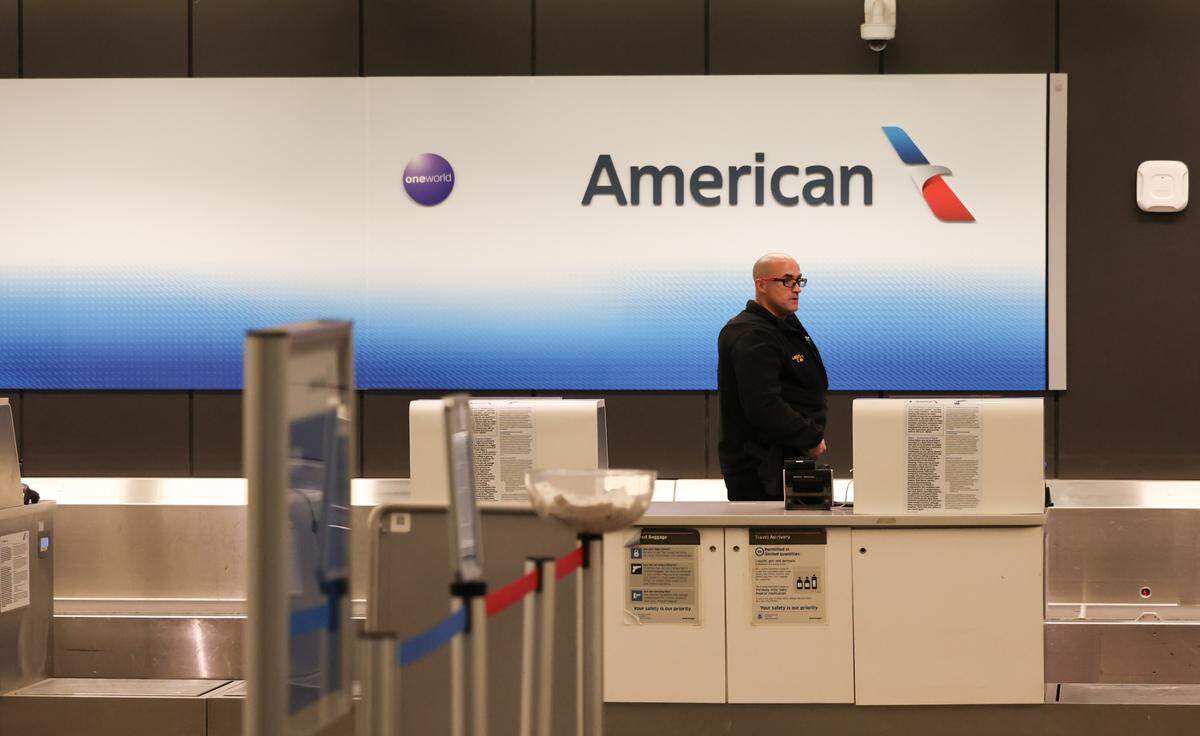 An airport security officer was on duty at the American Airlines counter Wednesday, Jan. 29, 2025, at Eisenhower National Airport in Wichita. An American Airlines flight that originated in Wichita crashed just miles short of its destination at Reagan National Airport in Washington, D.C., after it collided with a military helicopter.