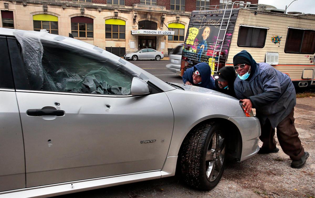 Employees of Young Auto Repair move a bullet-ridden Pontiac to their lot for repair in the 3100 block of North Grand Boulevard on Wednesday, Oct. 7, 2020. The shop, which opened in 1977, is sandwiched between Bing Lau Chop Suey and and the former Bad Habitz Social Club, where shootings outside both businesses this year have left three men dead and four wounded. “We can’t even conduct business in a normal way without being worried about people carrying guns,” said manager Kae Chris. Though the body shop does all types of work, bullet holes are a common repair.