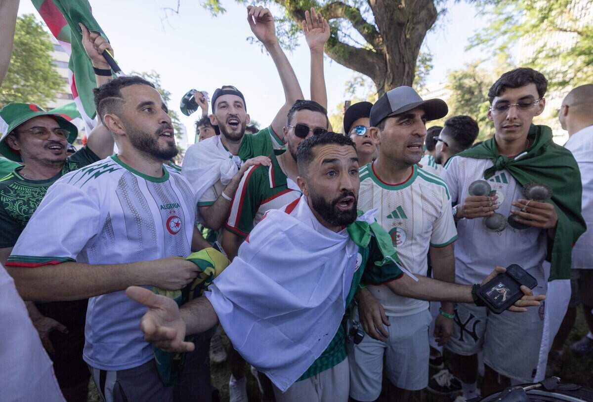 Algerian fans rally at Washington Park near Union Station the night before their team takes on defending World Cup champ Argentina at Kansas City Stadium.