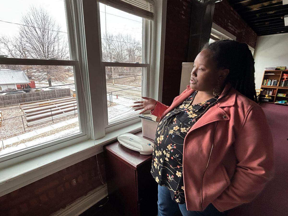 Alana Henry, executive director at the Ivanhoe Neighborhood Council, looks out on a site used for farm training at the nonprofit’s offices on Monday. The USDA recently cancelled a grant that would have helped the organization expand a local farmers market.