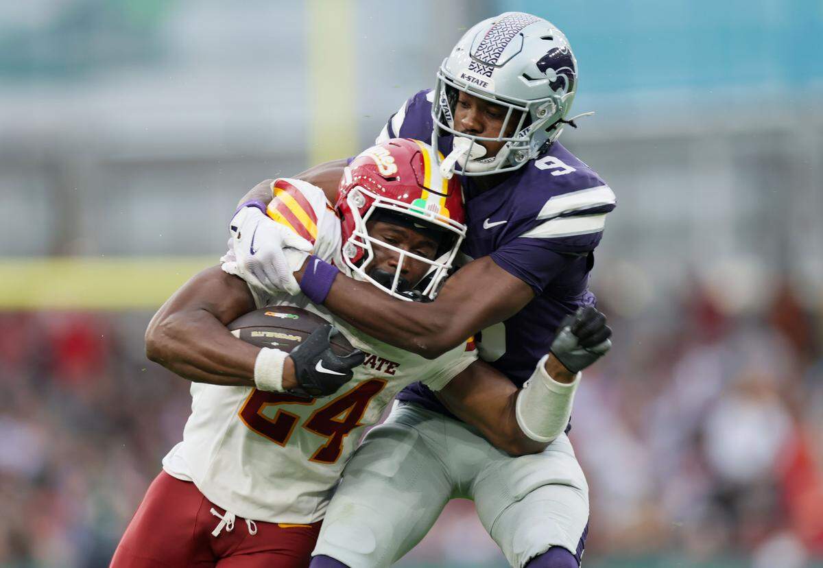 Iowa State player Abu Sama III is tackled by Donovan McIntosh of Kansas State during the Aer Lingus Classic at Aviva Stadium in Dublin on Aug. 23, 2025.