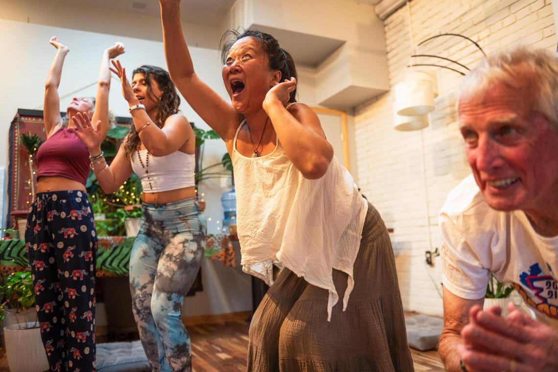 Laughter yoga students pretend to be laughing trees at Cafe Gratitude on Monday, June 19, 2023, in Kansas City.