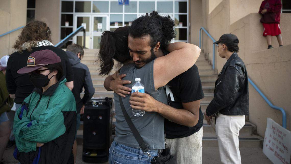 Zen Dixon, right, hugs Kateri Zuni, both from Albuquerque embrace following a press conference for Jayvon Givan in front of the John A. Price Law Enforcement Center in Albuquerque, New Mexico on Monday, Oct. 6, 2025.