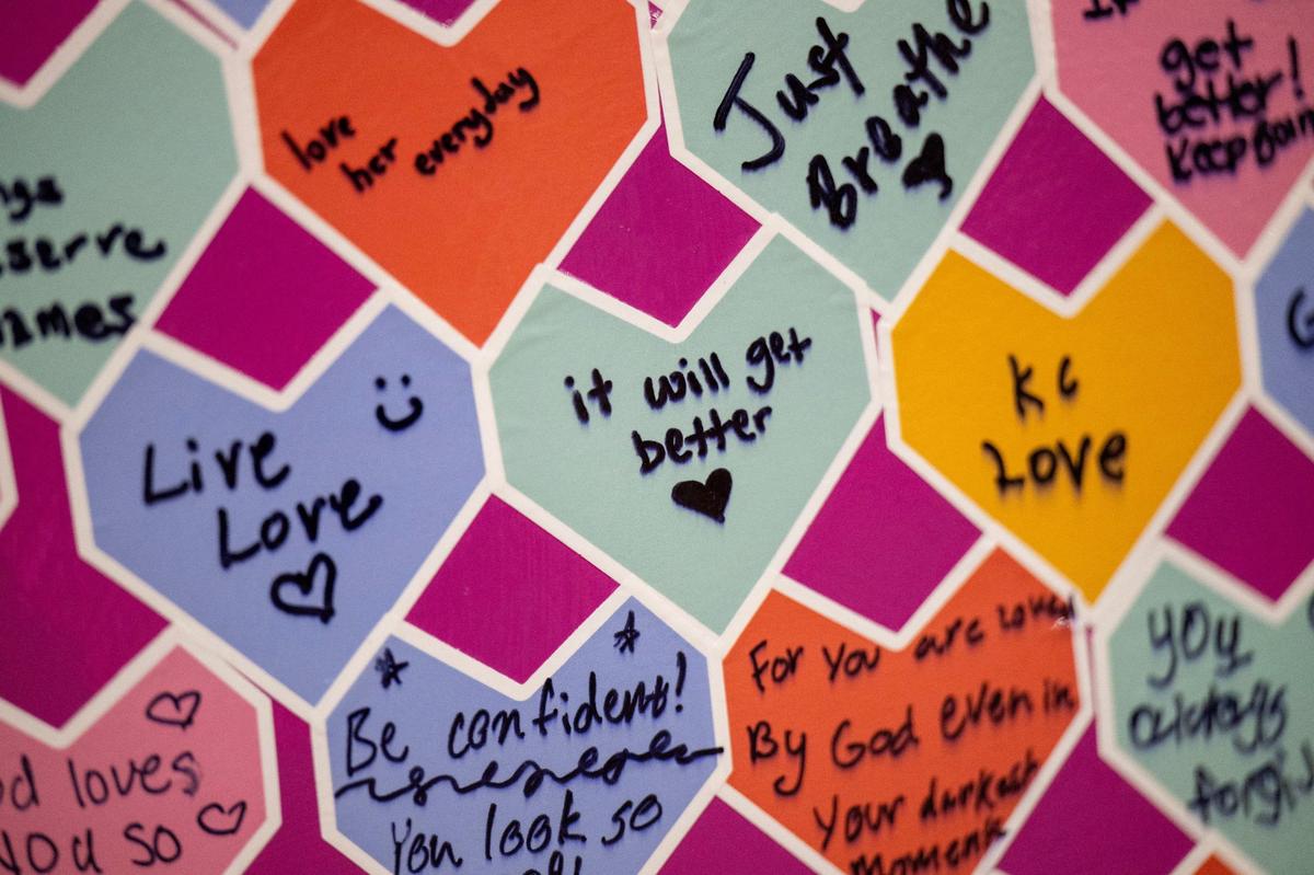 A variety of messages written on heart-shaped notes are seen as part of the heart called “Pathway to Healing” by artist Matt Dehaemers.