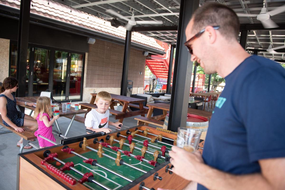 Daniel Zinser plays foosball with his son Cooper outside at City Barrel Pizza + Patio.
