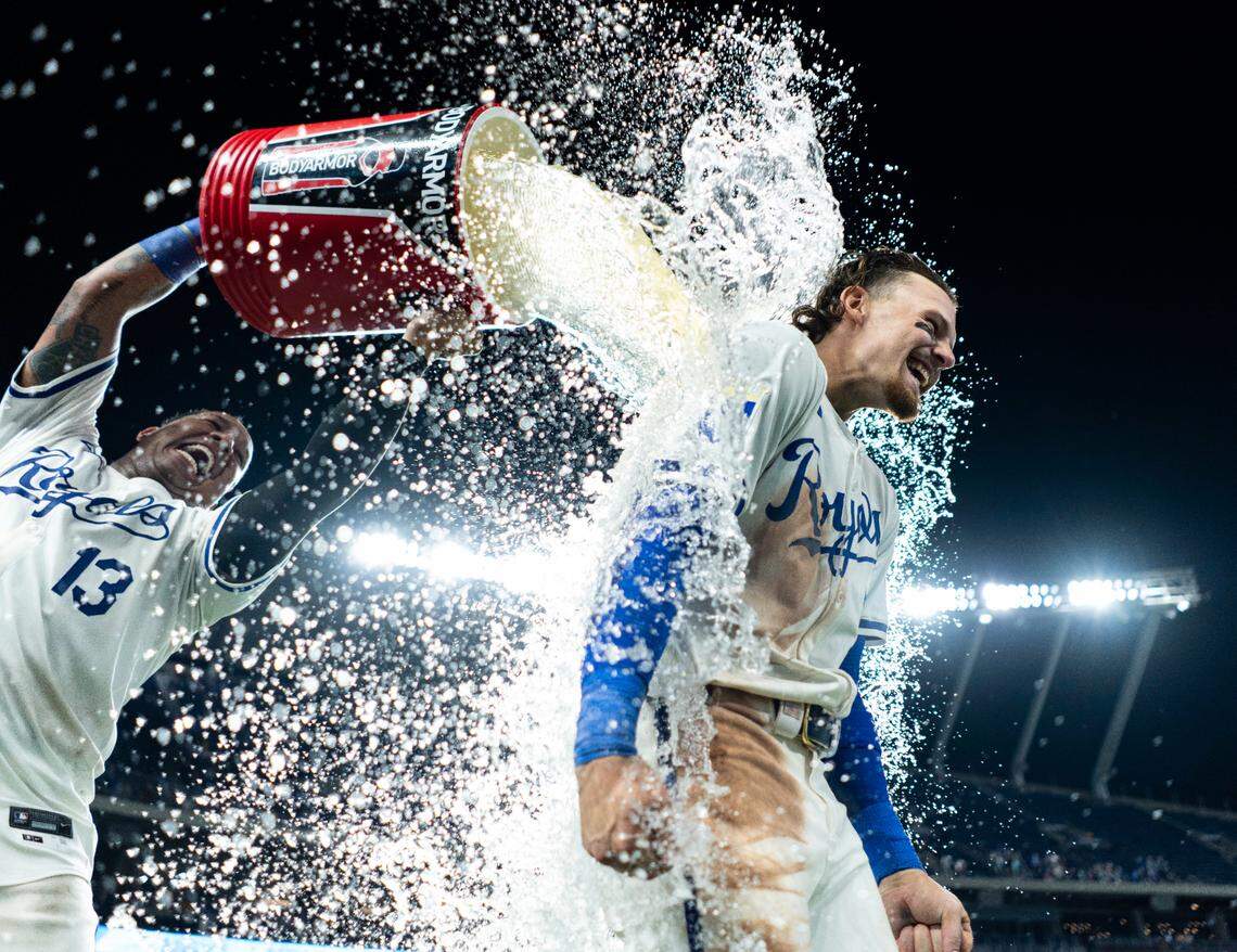 Kansas City Royals shortstop Bobby Witt Jr. (7) is doused with water by catcher Salvador Perez (13) after defeating the Arizona Diamondbacks at Kauffman Stadium on July 22, 2024.