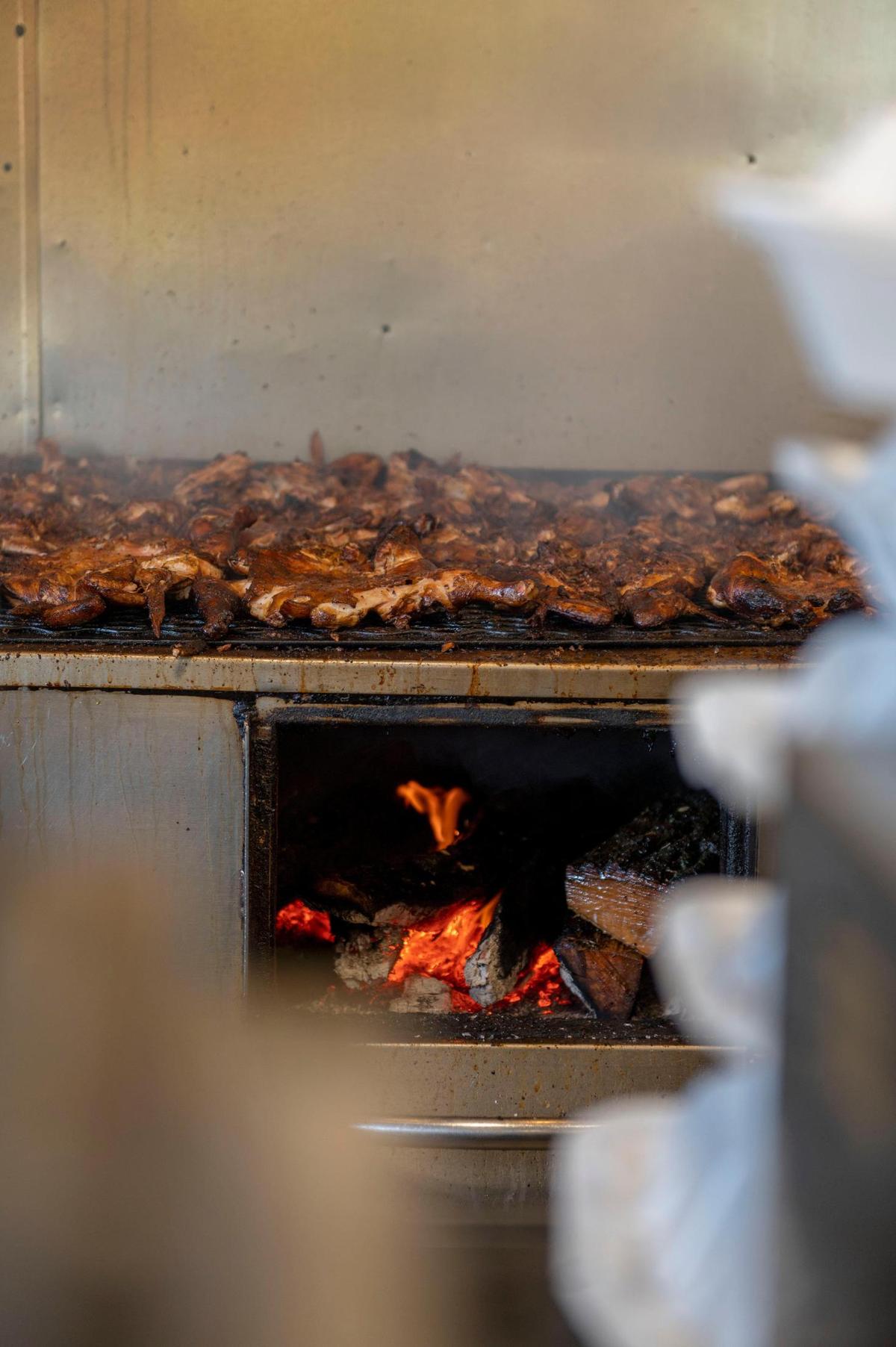 Whole chickens are grilled over high heat at El Pollo Rey. The wood smoke supplies the flavor. “What attracts people is that you walk in and you see the grill, you see the wood, you see the flames and they are cooking right in front of you,” said Edna Quintana, whose family owns the restaurant.