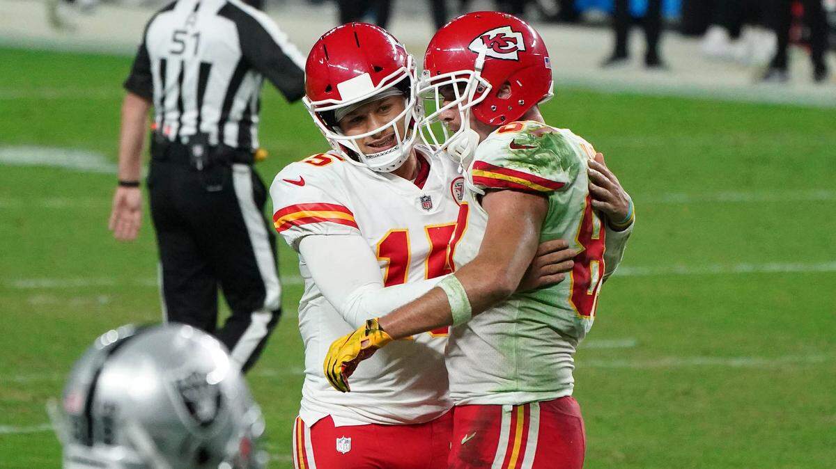 Kansas City Chiefs quarterback Patrick Mahomes (15) with tight end Travis Kelce (87) after a play against the Las Vegas Raiders during the second half at Allegiant Stadium.