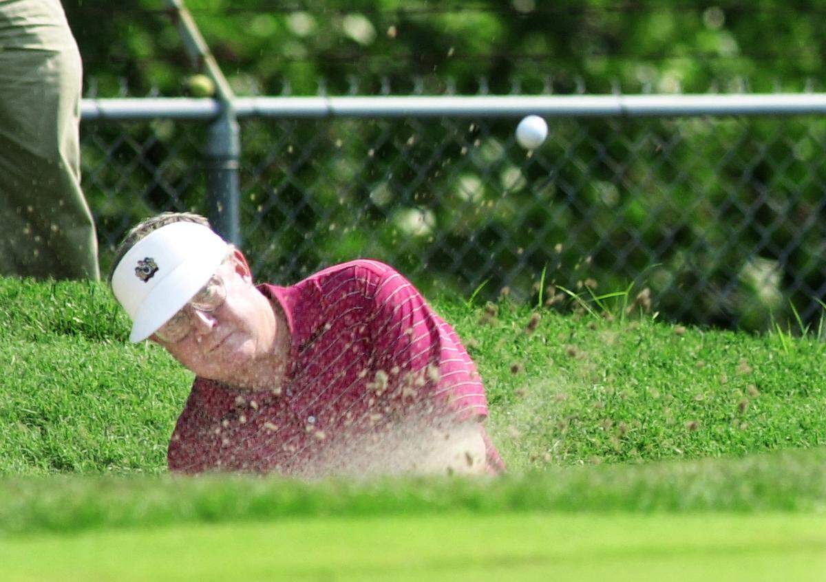 Even seasoned pros have found Kansas City Country Club’s 14th hole plenty challenging through the years. Here, Chip Stewart of Irving, Texas, hits out of the sand during a 2001 event.