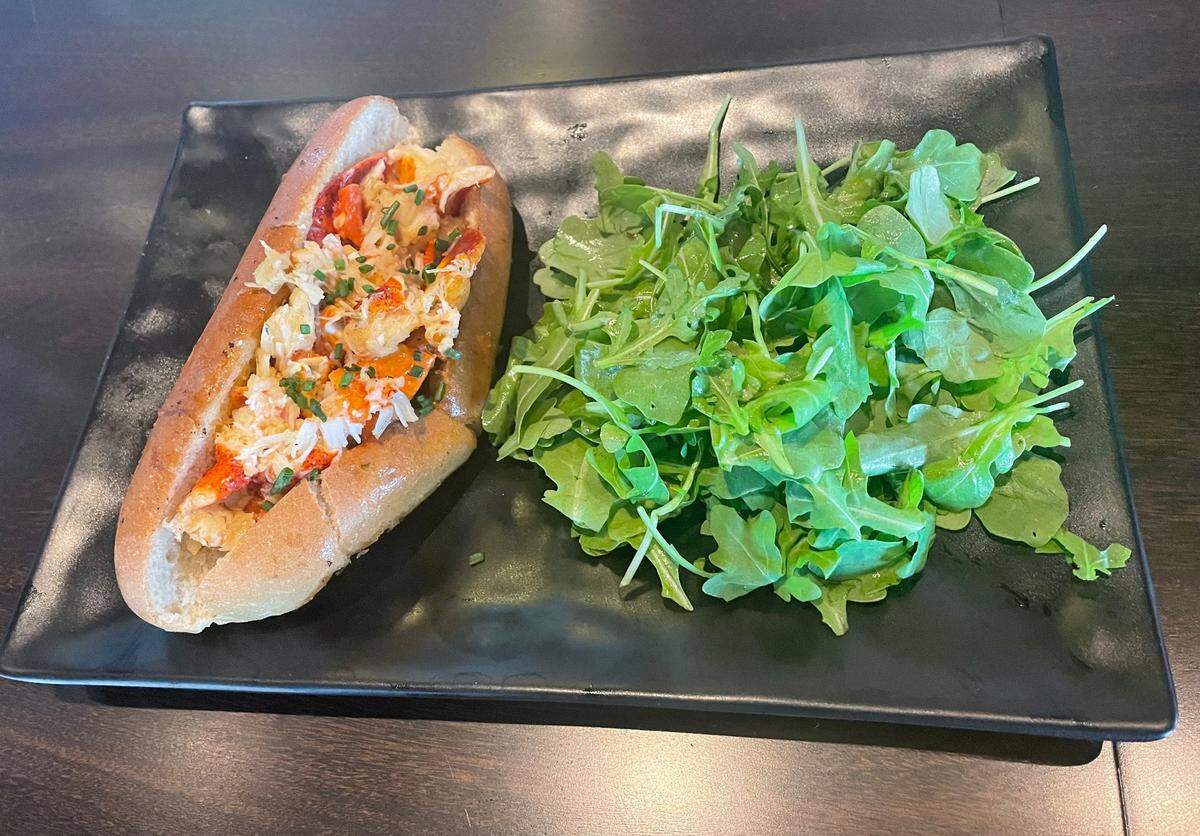 The warm lobster roll: poached Maine lobster, garlic butter, and chives on a split-top bun.