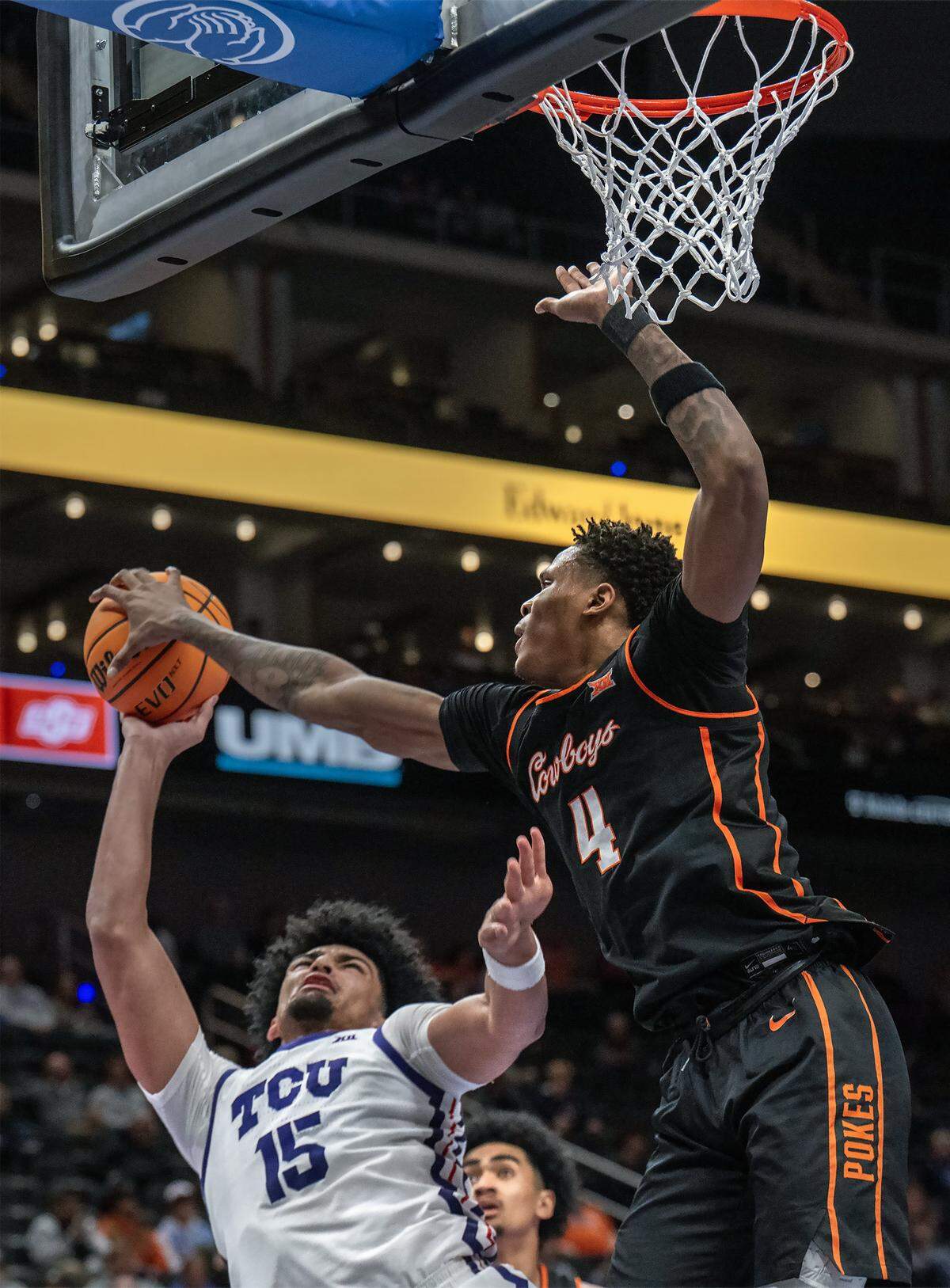 Texas Christian University Horned Frogs forward David Punch (15) is blocked by Oklahoma State Cowboys forward Christian Coleman (4) during the second half of the Big 12 Men's Basketball Tournament at T-Mobile Center on Wednesday, March 11, 2026, in Kansas City. TCU defeated OSU, 95-88.