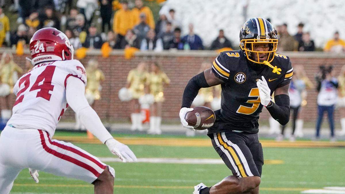 Missouri Tigers wide receiver Luther Burden III (3) runs the ball as Arkansas Razorbacks Quincey McAdoo (24) defends during the second half at Faurot Field at Memorial Stadium on Nov. 25, 2022.