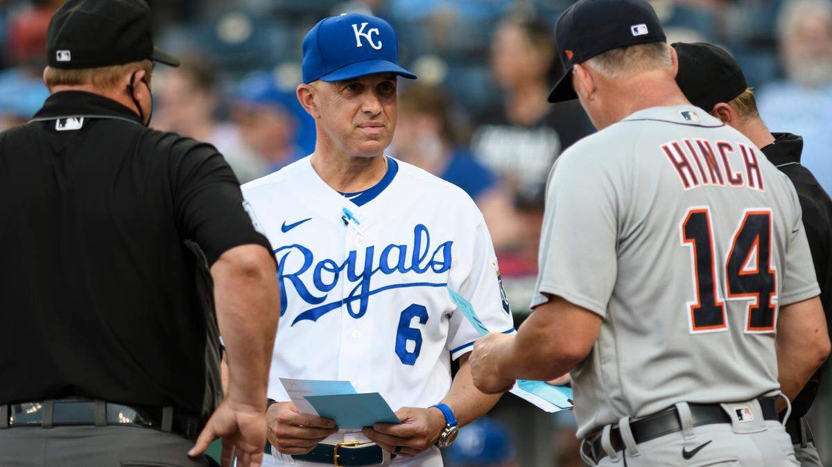 Kansas City Royals bench coach Pedro Grifol meets with Detroit Tigers manager A.J. Hinch and the umpires before the start of their baseball game in Kansas City, Mo., Monday, June 14, 2021. (AP Photo/Reed Hoffmann)
