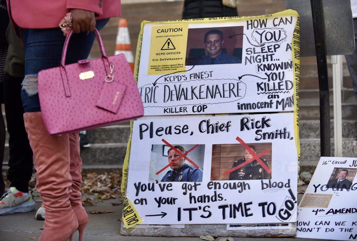 A sign sits on the stairs outside the Jackson County Courthouse on Monday, Nov. 8, 2021, during the trial of Eric DeValkenaere, who is charged with first-degree involuntary manslaughter and armed criminal action in the killing of Lamb, 26, on Dec. 3, 2019.