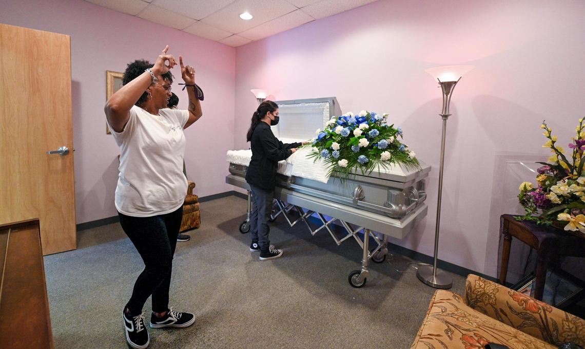 Mortician Gwendelrae Hicks, left, signaled the end of a respectful and successful preparation of a deceased man at her Northern Star Mortuary in Kansas City, Kansas. Her assistant funeral director, Amberlie Gonzalez, looked over the casket in the funeral home’s viewing room.