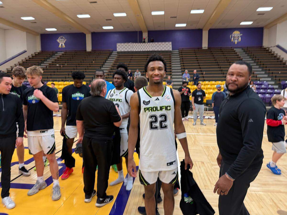 Future KU basketball guard Darryn Peterson (22) stands with his dad, Darryl, right, on the court after Prolific Prep’s victory in The Grind Session’s world championship title game at Haskell Indian Nations University on Sunday, March 23, 2025.