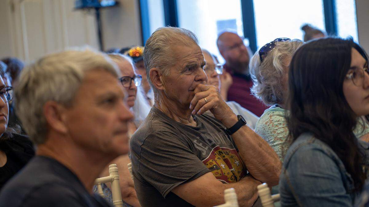 A community member reacts during a presentation at a town hall meeting at The Rhapsody on Tuesday, June 2, 2026, in Independence. The meeting focused on opposition to the proposed Nebius data center project.