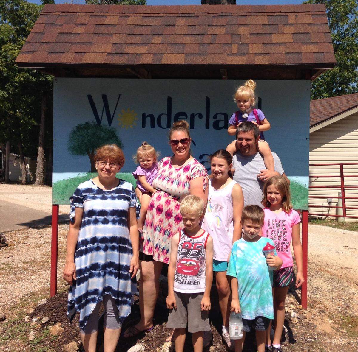 The Bisher family is pictured at a camp for children with special needs. Isabella, top right, has a serious breathing disorder and requires 16 hours of home nursing care a day.