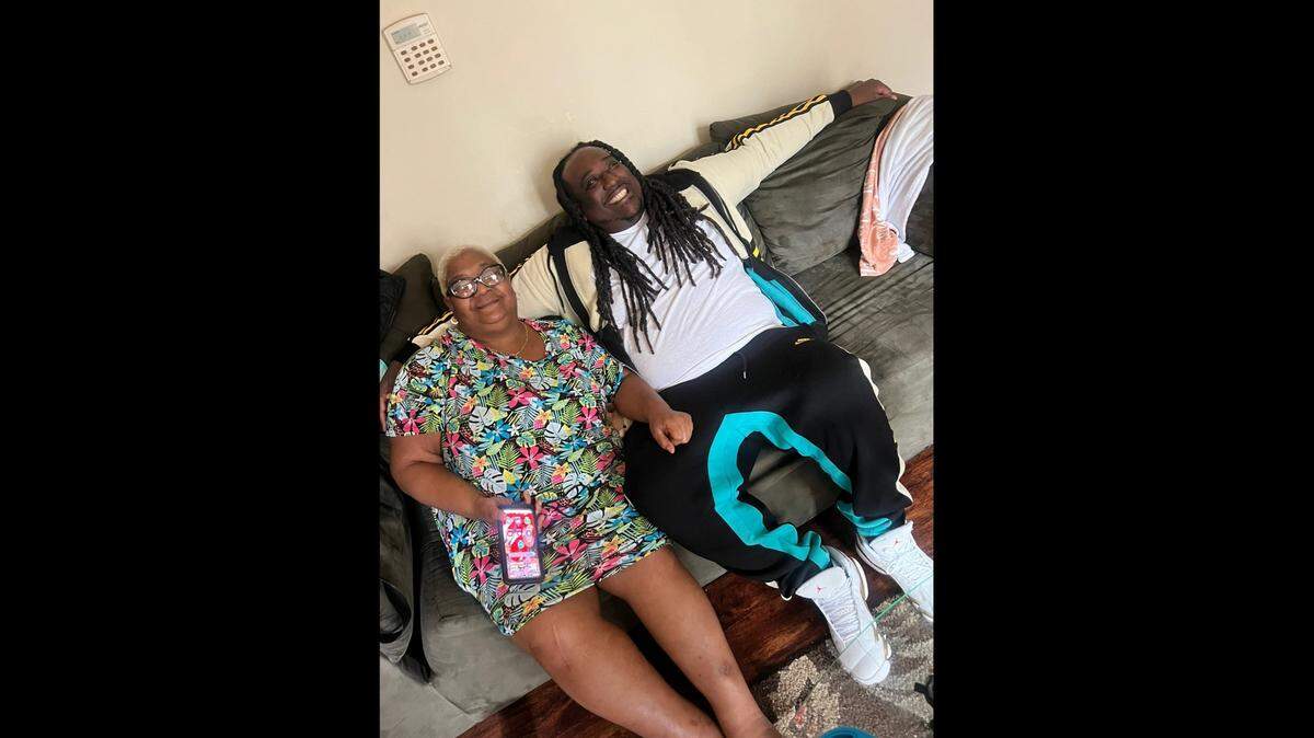 Carolyn Gorham, 52, and her son Keith Gorham, 37, sitting on the couch together at a family gathering in March.