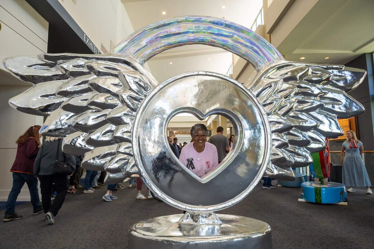 Parade of Hearts Board Chair La'Von Colhour poses for a photo inside “There's No Place Like Chrome,” a heart design by artist TrewLove, during the first public exhibition of the new hearts titled “150 United,” on Saturday, April 4, 2026, in Overland Park. This heart is found at Loews Hotel, 1515 Wyandotte St.