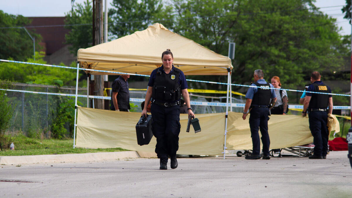Crime scene personnel collect evidence where a man was found dead at the 3400 block of Broadway Boulevard in Kansas City on June 12, 2025.