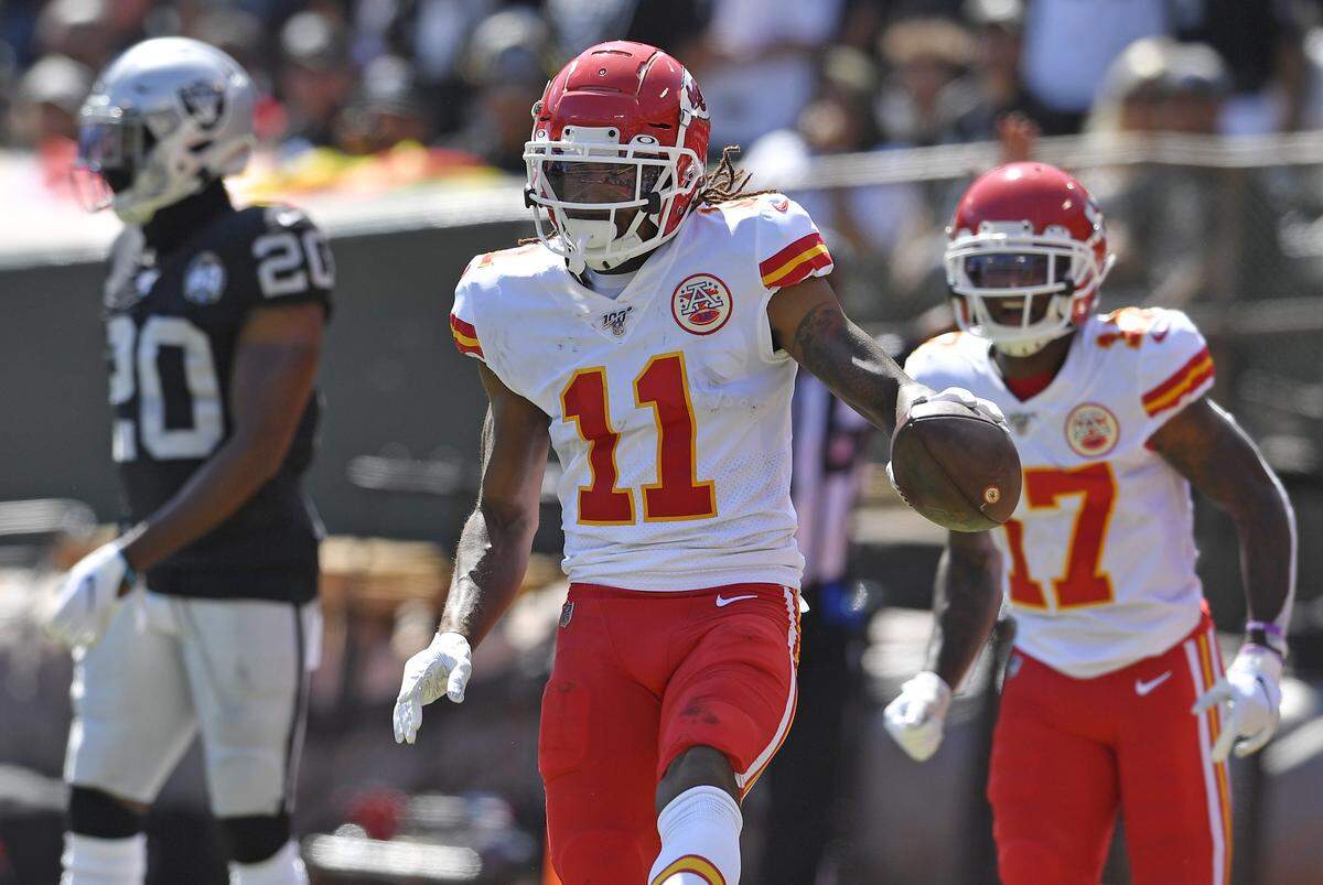 The Chiefs Demarcus Robinson (11) celebrates his first half touchdown over the Oakland Raiders‚Äô Daryl Worley Sunday at Oakland Alameda County Coliseum.