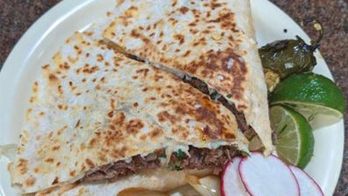 Taqueria La Nueva’s quesadilla — a large flour tortilla with cheese, cilantro, onion and a choice of meats. It has 11 different meat options.