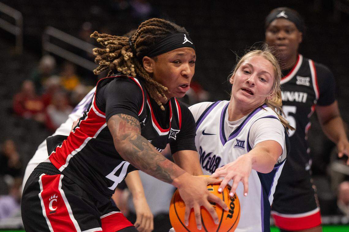 Kansas State guard Taryn Sides (11) attempts to steal the ball from Cincinnati Bearcats guard Caliyah Devillasee (4) during the second half of the Wildcats’ first-round game vs. the Cincinnati Bearcats in the Big 12 Women’s Basketball Tournament.