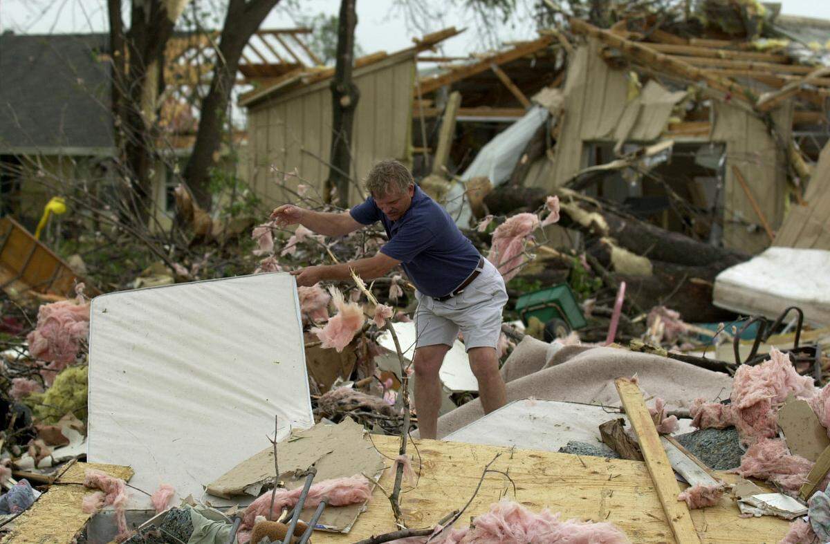 Thomas Hadzel of Kansas City, Kansas, searched through debris after a tornado passed through a neighborhood near 102nd Street and Parallel Parkway in Kansas City, Kansas, on May 4, 2003.