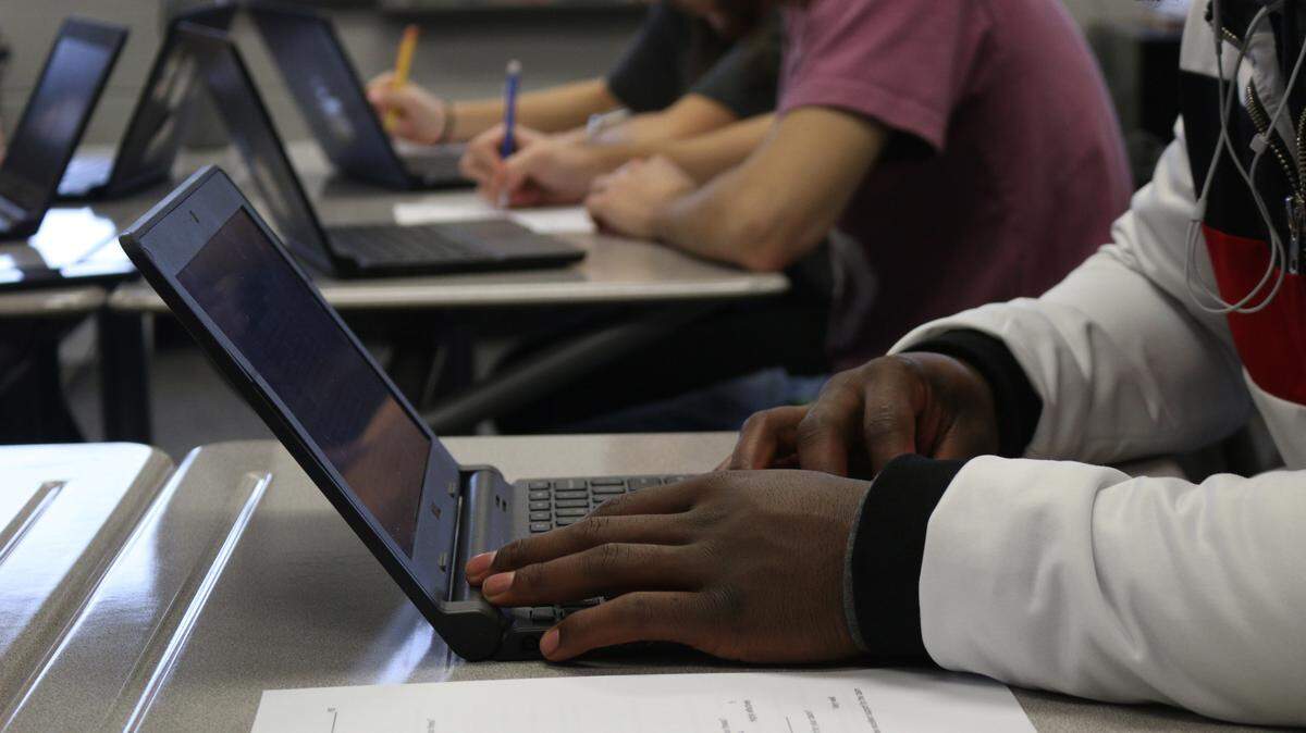 Senior English IB students at Lee’s Summit North High School work on essays in class, using their school-provided laptops. Integrating technology and internet into lessons is standard in schools now.