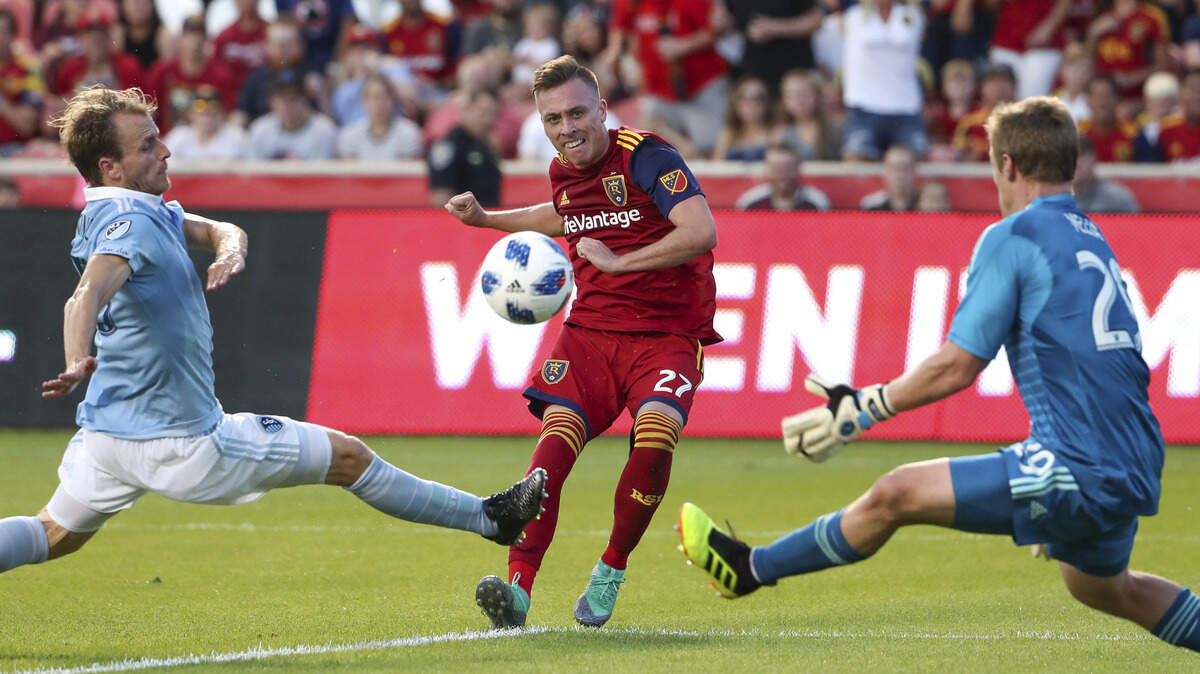 Real Salt Lake forward Corey Baird (27) hit a shot past Sporting Kansas City goalkeeper Tim Melia (29) and into the net during the first half of Sporting KC's 4-2 defeat in Sandy, Utah.